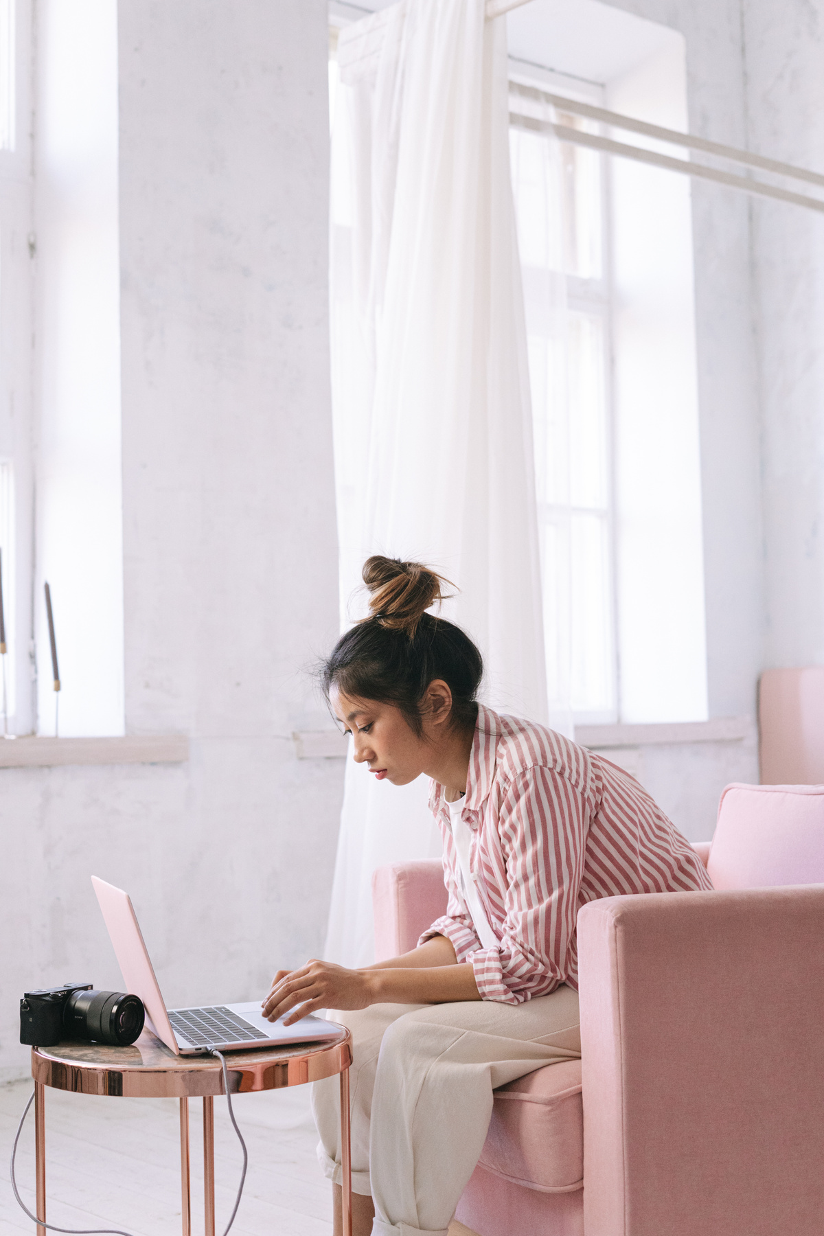 Woman in Stripe Long Sleeves Sitting on Pink Chair